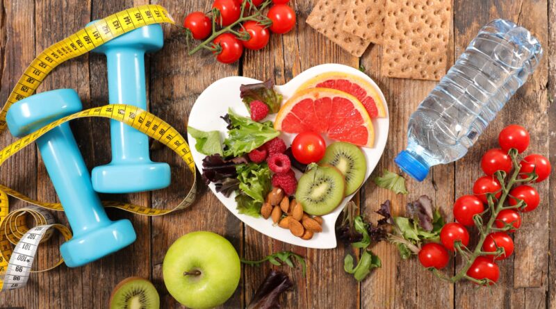 healthy food, apple, water bottle, dumbbells for workout