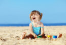 little girl is playing on the beach