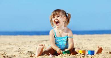 little girl is playing on the beach