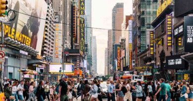 many people crossing the crosswalk on foot