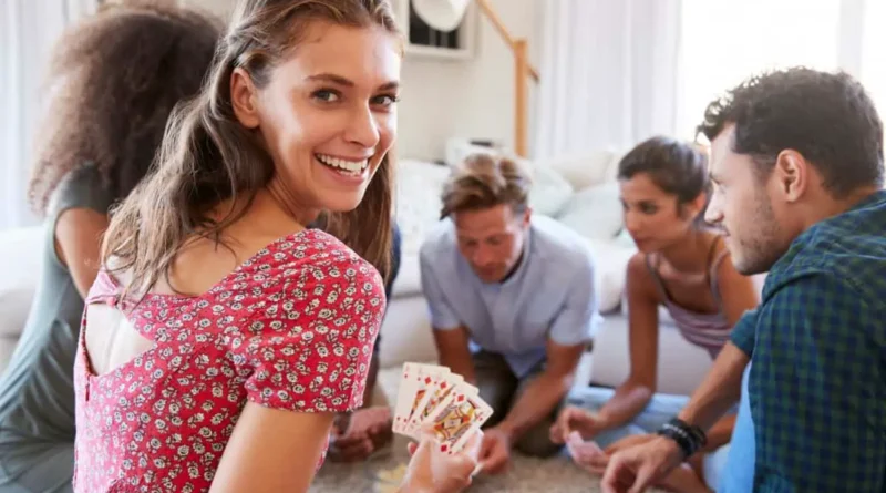 men and women play poker in a home setting