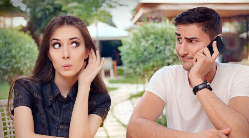 A woman tries to listen to her husband's phone conversation.